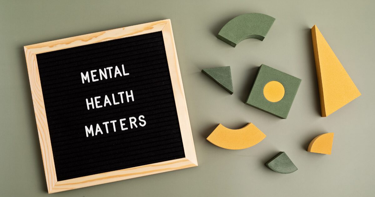 - Treat Mental Health Washington Black felt letter board reads 'MENTAL HEALTH MATTERS' beside green and yellow foam geometric shapes on a muted green background, conveying mental health awareness.