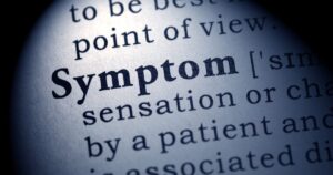 - Treat Mental Health Washington Close-up of a dictionary page with the word 'Symptom' in bold focus.