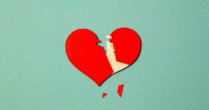 - Treat Mental Health Washington Broken red heart on a teal background with jagged split and scattered shards beneath it, symbolizing heartbreakled