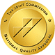 Gold circular quality certification seal with a diagonal emblem and a gold finish.
